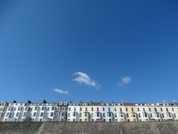 Low angle view of buildings against blue sky