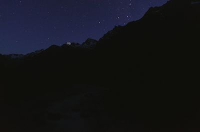 Scenic view of silhouette mountain against sky at night