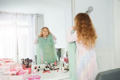 Rear view of mother and daughter at home