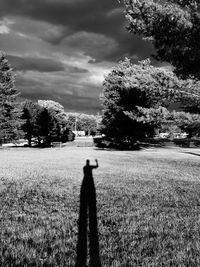Shadow of man walking on road