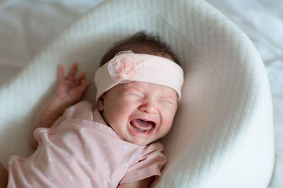 Portrait of cute baby boy sleeping on bed