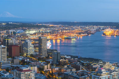 High angle view of illuminated city buildings against sky