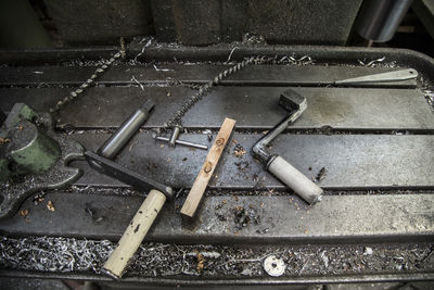 High angle view of work tools on metal table