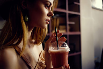 Close-up of young woman drinking coffee