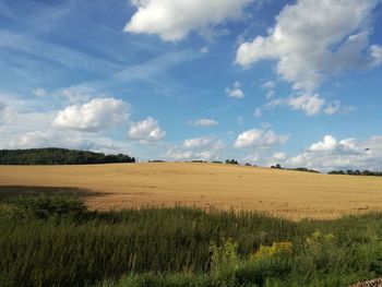 Scenic view of landscape against cloudy sky