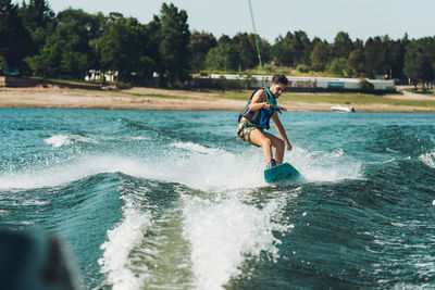 Full length of man doing wakeboard in a lake