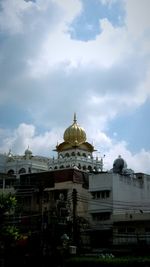 Low angle view of building against cloudy sky