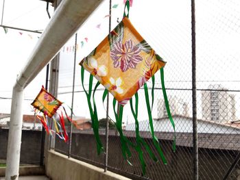 Low angle view of multi colored flags hanging on fence