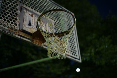 Low angle view of glass decoration hanging in yard