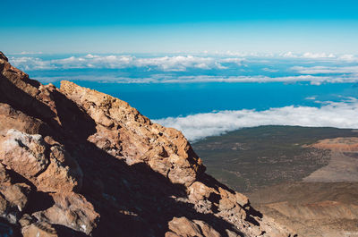 Scenic view of mountains against blue sky