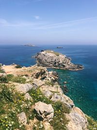 High angle view of rocks by sea against sky