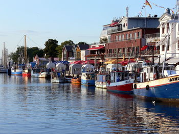 Boats in sea against clear sky