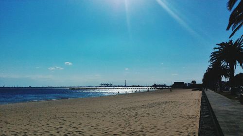 Scenic view of beach against blue sky