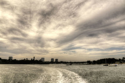 Scenic view of beach against sky in city