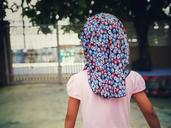 Rear view of girl wearing floral headscarf
