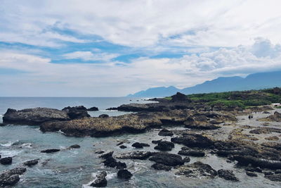 Scenic view of sea against cloudy sky