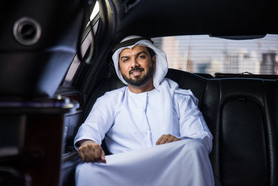 Portrait of a young man sitting in car