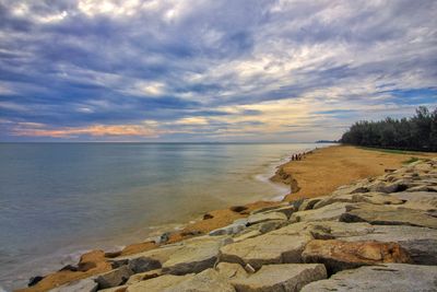 Moody clouds over sandy coastline