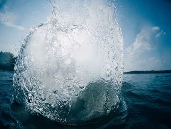 Close-up of water splashing against sky