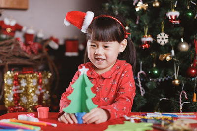 Cute boy looking at christmas tree