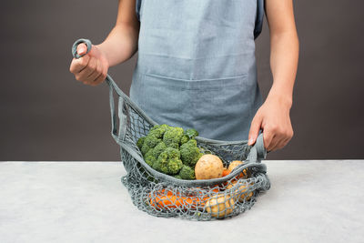 Mesh bag vegetables, shopping grocery, healthy food ingredient, potato, broccoli carrot, zero waste
