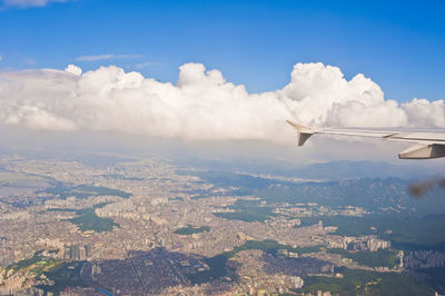 Aerial view of landscape against cloudy sky