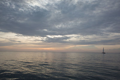 Scenic view of sea against cloudy sky