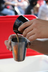 Midsection of woman drinking coffee