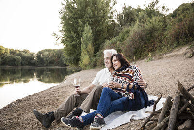 Relaxed senior couple at a lake in the evening