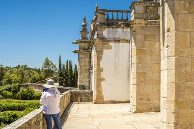 Man in front of historical building against sky