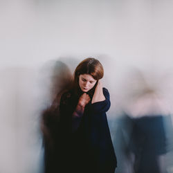 Young woman against wall