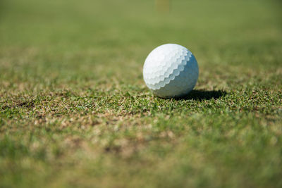 Close-up of golf ball on field