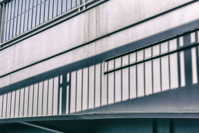 Low angle view of railing shadow on bridge