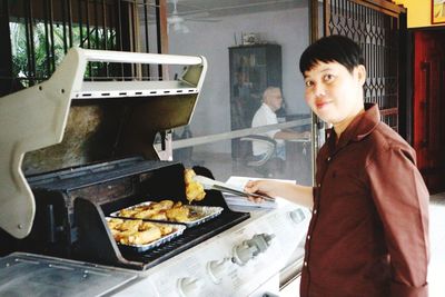 Portrait of young man preparing food in restaurant