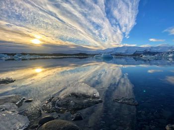 Scenic view of frozen lake against sky during winter