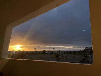 Scenic view of sunset seen through window