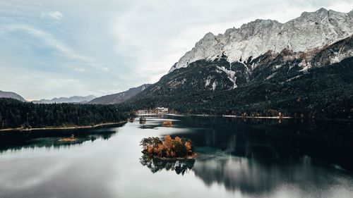 Scenic view of lake and mountains against sky