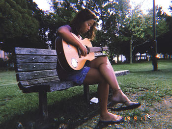 Man sitting on bench in park