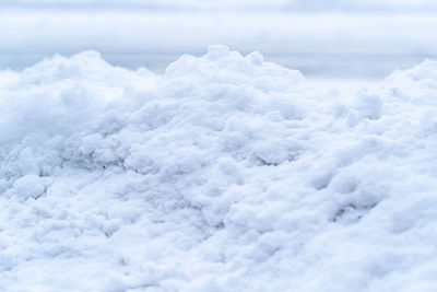 Close up of snow pile alongside a road