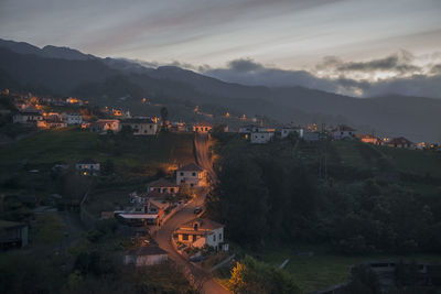 High angle view of townscape and mountains against sky