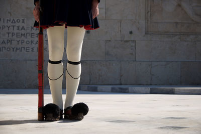 Low section of woman standing on tiled floor