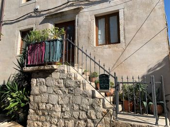 Low angle view of potted plants on old building