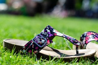 Colorful sandals on grass in summer 