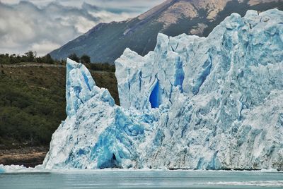 Scenic view of frozen sea against mountain