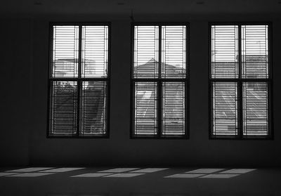 Rear view of woman looking through window