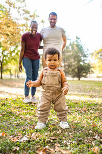 Portrait of boy playing with brother on field