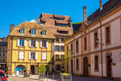 Low angle view of buildings against blue sky