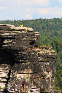 View of people on rock against sky