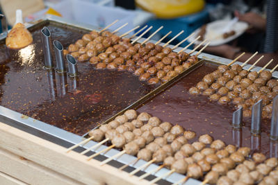 High angle view of pork ball dip in sauce for sale at market