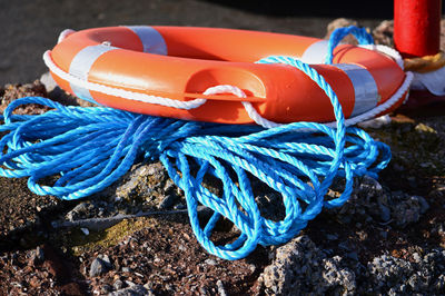 Close-up of life belt and rope on rock